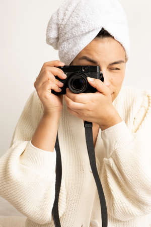 Young woman looking the laptop in her bed after shower with a towel on her headの写真素材