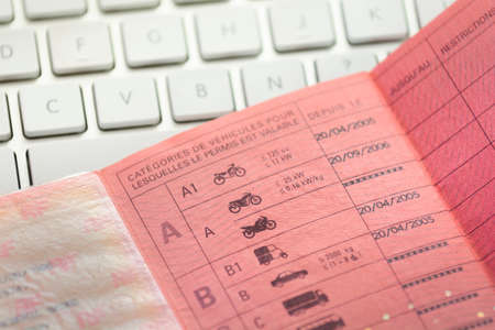 Inside a french driver licence and white keyboardの写真素材