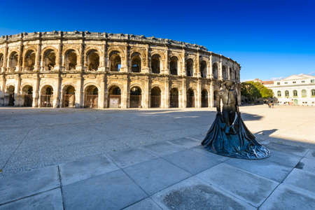 Statue and Arena of Nimes in France Statue and Arena of Nimes in France