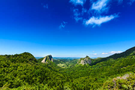 Tuiliere rocks and mountains in Auvergne landscape with blue sky, Franceの写真素材