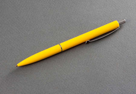 Yellow pen on a gray backgroundの写真素材