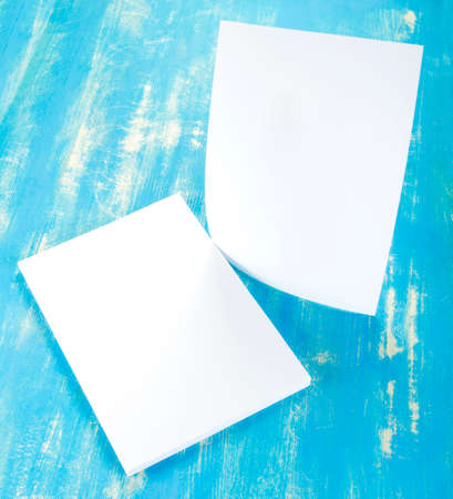 Blank flyer poster on wooden background to replace your designの写真素材