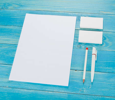 Blank Stationery on wooden background. Consist of Business cards, A4 letterheads, pen and pencil