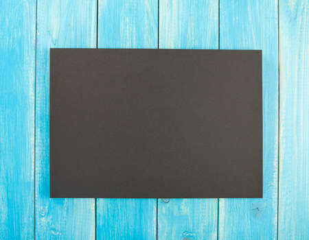 Blank flyer poster on wooden background to replace your designの写真素材