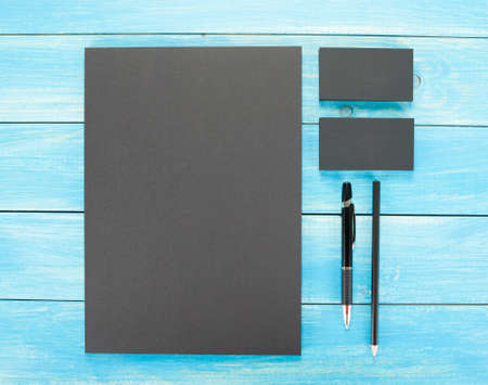Blank Stationery on wooden background. Consist of Business cards, A4 letterheads, pen and pencil