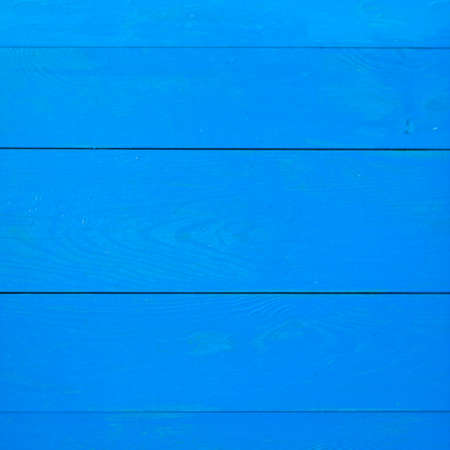 A blue wooden wall with horizontal planks. Close up of an old wooden fence panelsの写真素材