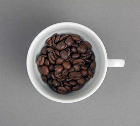 Top view of the cup filled up with coffee beanの写真素材