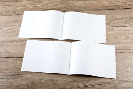 Blank catalog, brochure, magazines, book on wooden background, top view