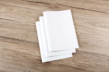 Blank catalog, brochure, magazines, book on wooden background, top viewの写真素材