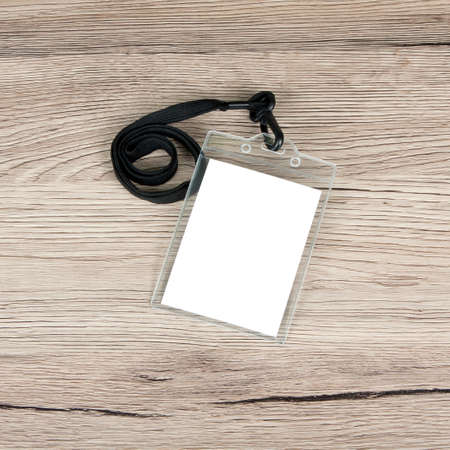 Name id card badge with cord on wooden background