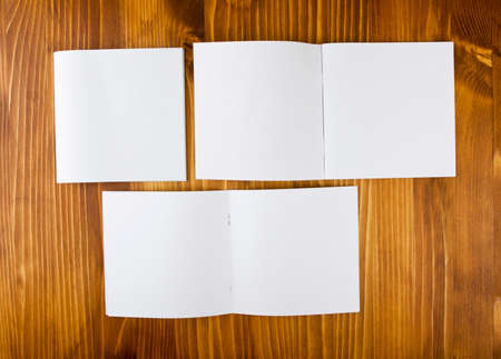 Blank catalog, brochure, book mock up. Empty opened magazine on wooden background
