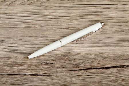White pen on a wooden background