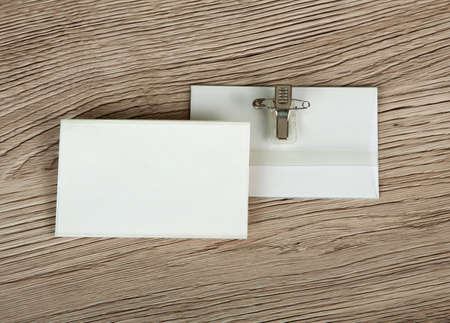 Name tag or identification holder with metal clip on wooden surfaceの写真素材