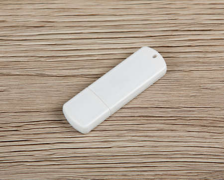 White usb flash drive on wooden backgroundの写真素材