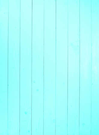 A blue wooden wall with vertical planks. Close up of an old wooden fence panelsの写真素材