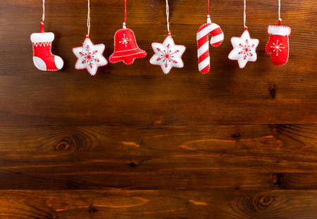 Hanging Christmas and New Year decorations on a wooden background