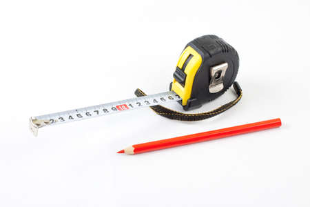 Black tape-measure with red pencil on a white backgroundの写真素材