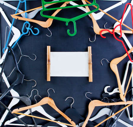 Black Friday shopping sale concept. Clothes hangers with copy space on black background.の写真素材