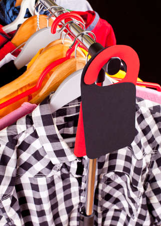 Black Friday shopping sale concept. Sale in a clothing store - discount sign at a clothes rackの写真素材