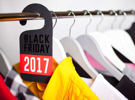 Black Friday shopping sale concept. Sale in a clothing store - discount sign at a clothes rack