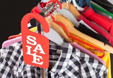Black Friday shopping sale concept. Sale in a clothing store - discount sign at a clothes rackの写真素材