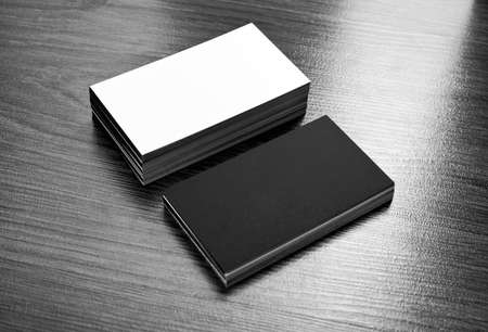 Mockup of white and black business cards at wooden background. Template for branding identity