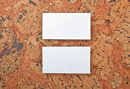 Mockup of white business cards at a cork background. Template for branding identityの写真素材