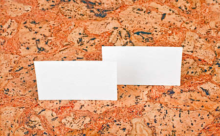 Mockup of white business cards at a cork background. Template for branding identityの写真素材
