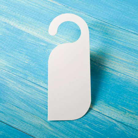 White door hanger on a blue wooden planksの写真素材