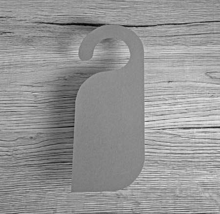 Gray door hanger on a wooden backgroundの写真素材
