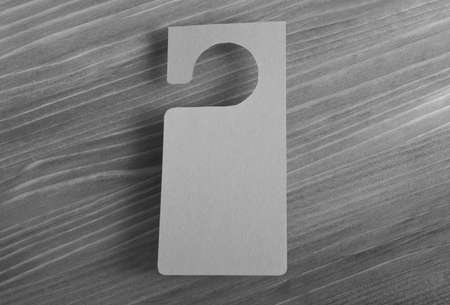 Gray door hanger on a wooden backgroundの写真素材