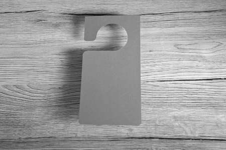 Gray door hanger on a wooden backgroundの写真素材