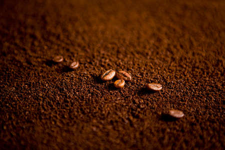 Coffee beans on coffee powder. Macro shotの写真素材
