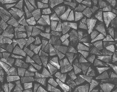 Dry chopped firewood logs ready for winter as background or texture