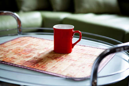 The red cup is on the coffee tableの写真素材