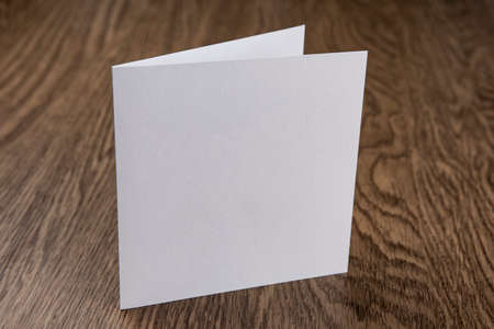 Mockup of white booklet on wooden background