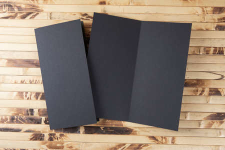 Mockup of black booklet on bamboo background.の写真素材