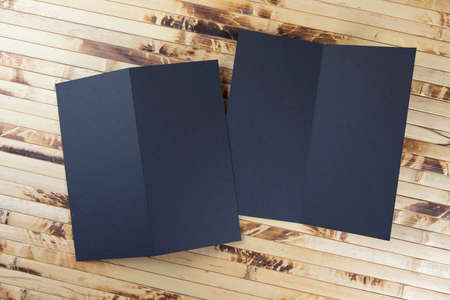 Mockup of black booklet on bamboo backgroundの写真素材