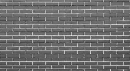 Empty gray brick wall textured backgroundの写真素材