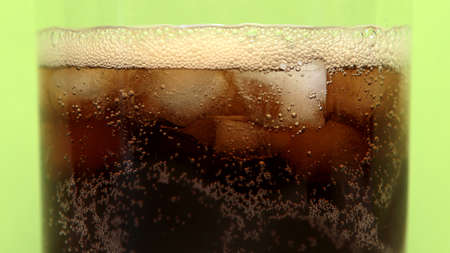 Close up view of the ice cubes in cola background