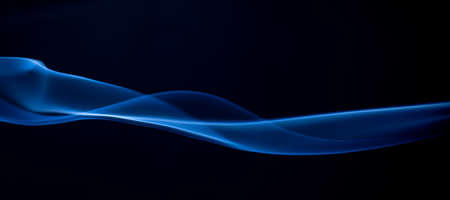 Abstract blue smoke swirls on dark background