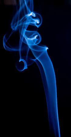 Abstract blue smoke swirls on dark backgroundの写真素材