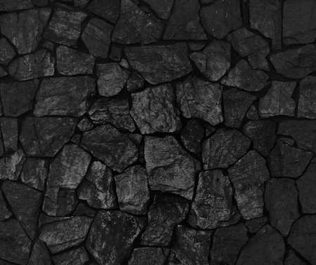 Background of black stone wall textureの写真素材