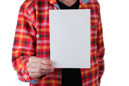 A man in a colored shirt holding a white letterhead
