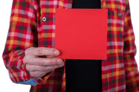 A man in a colored shirt holding a red note paperの写真素材