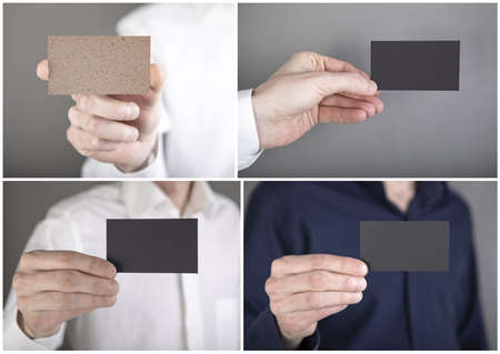 A man in a blue shirt holding a black business card
