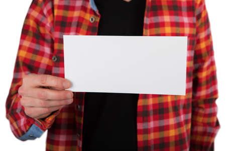 A man in a colored shirt holding a white flyer