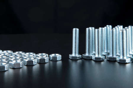 Nuts and bolts closeup on black background