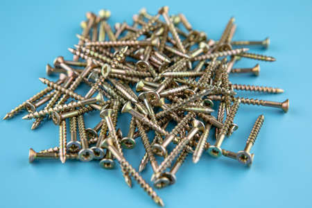 Pile of metal screws for performance of works. The drill metal screws