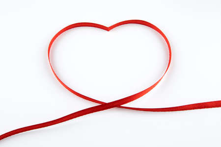 Shiny red ribbon on white background with copy space